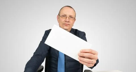 Man holds an empty envelope in the camera Stock Photos
