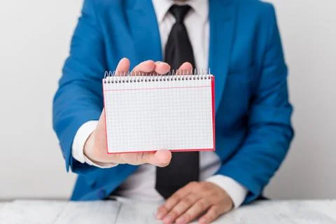 Man holds empty paper with copy space in front of him. Business concept with man Stock Photos