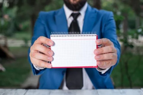 Man holds empty paper with copy space in front of him. Business concept with man Stock-Fotos