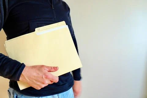 A man holds a folder with documents in his hands Fotos de archivo