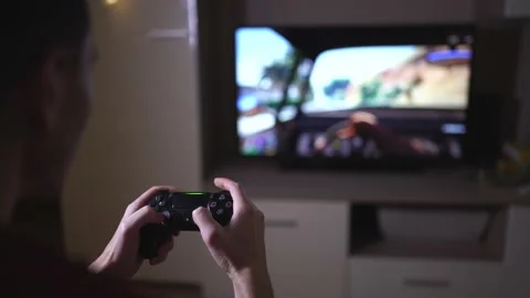 A man holds a gamepad and plays a game Stock Footage 169278745