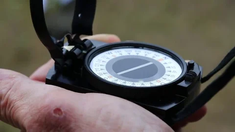 Man holds in hand compass Stock Footage 69143119