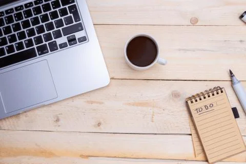 Man holds in hand a notepad. notebook, phone, cup of coffee near Stock Photos