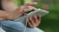 Man holds in hands white tablet pc. Man looks the photos in his tablet computer HD Footage