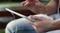 Man holds in hands white tablet pc. Man looks the photos in his tablet computer HD Footage