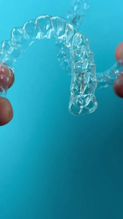 A man holds in his hand transparent aligners plastic braces retainers for s.. Stock Footage 320461219