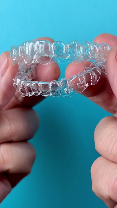 A man holds in his hand transparent aligners plastic braces retainers for s.. Stock Footage 320461230