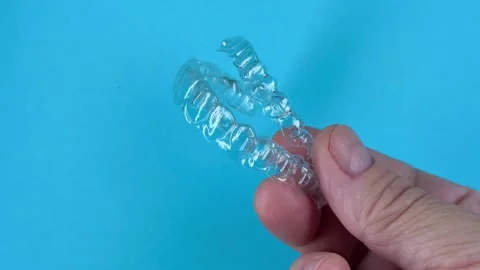 A man holds in his hand transparent aligners plastic braces retainers for s.. Stock Footage 320461361
