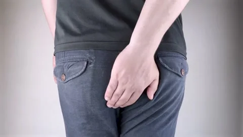 A man holds his hands to the ass feeling pain. Conversion of pain in the rectum, Stock Footage 130247883