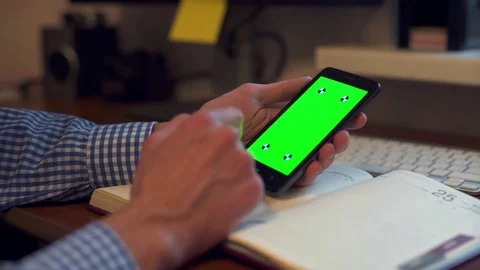 Man holds in his hands a smart phone with green screen. Stock Footage 69971580
