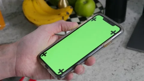 Man holds up iPhone green screen Stock Footage 157515902