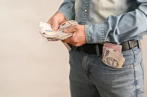 Man holds large stack of ukrainian hryvnia banknotes in hands. 스톡 사진