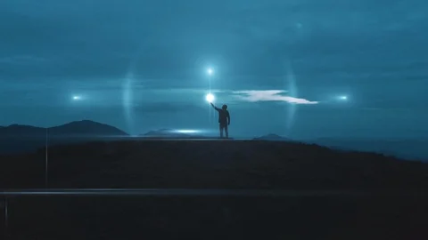 The man holds a magic light ball on the mountain top Stock Footage 120002492