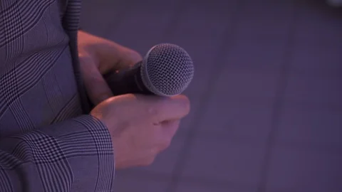Man holds microphone Stock Footage 102274047