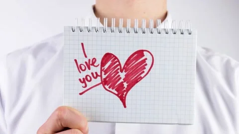 A man holds a note I love you. Declaration of love. Stock Footage 208908084