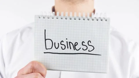 A man holds a notepad, a notebook with the inscription BUSINESS. Stock Footage 208908245