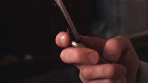 Man holds outdated clamshell mobile phone in his hand, opens it, dials a number Stock Footage 205225310