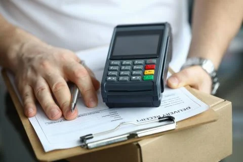 Man holds parcel delivery document and terminal 写真素材
