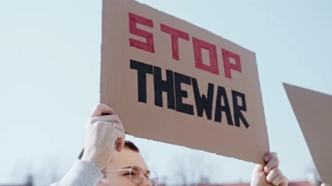 Man holds a poster with the quote stop the war Video stock 171933573