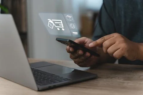 Man holds a smartphone and points at a shopping app with cart, package, int.. Stock Photos