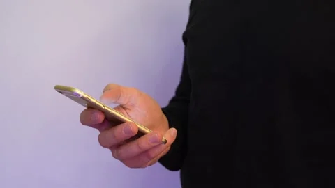 A man holds a smartphone and uses a touchscreen. Stock Footage 142400593