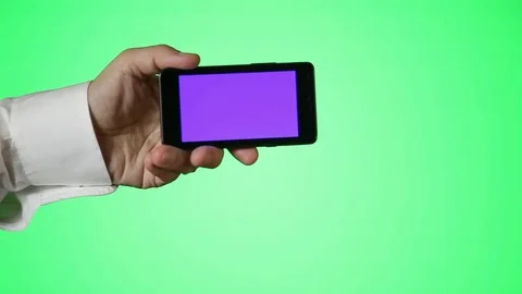 Man Holds Smartphone in front of Greenscreen Stock Footage 81482249