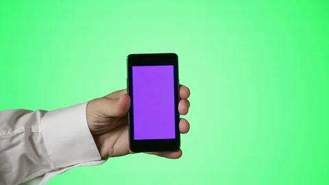 Man Holds Smartphone in front of Greenscreen Stock Footage 81489349