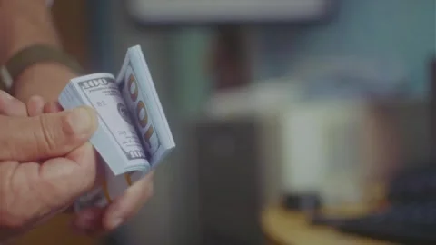 A man holds a stack of banknotes in his hands Stock Footage 310009874