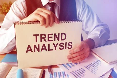 Man holds Trend analysis with stack of papers. Stock Photos