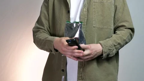 A man holds a TV remote control, presses it and switches channels Stock Footage 312169417