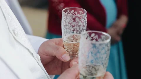A man holds two glasses filled with champagne in his hands. Close-up shooting Stock Footage 157930542