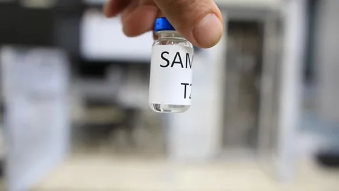A man holds a vial with a sample of water to perform trace analysis looking for  Stock Footage 254600530