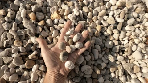 Man holds white pebble Stock Footage 121392936