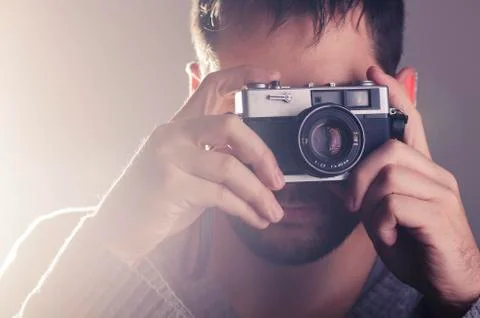 Man holiding retro camera Stock Photos