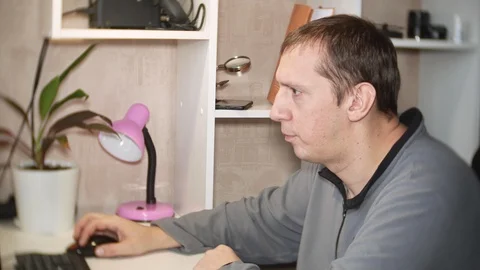 The man at home is behind a computer. 스톡 동영상 121686260