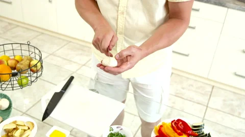 Man at home carves pattern on champignons before frying for beautiful decoration Stock Footage 141257051