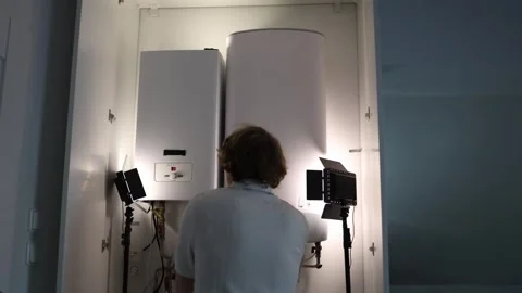 Man at home checking heating boiler and water tank before the start of the heati Stock Footage 318868682