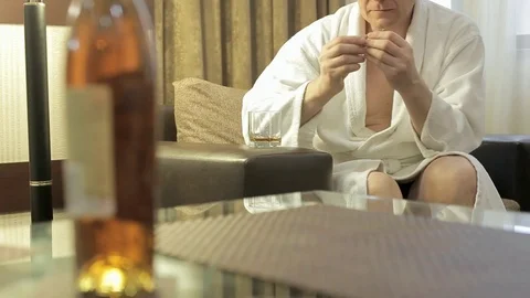 A man in home clothes twists a ring in his hands and is nervous Stock Footage 123745872