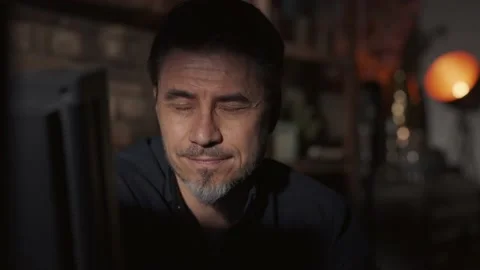 Man at home in dark room looking at computer screen and thinking Stock Footage 155120964