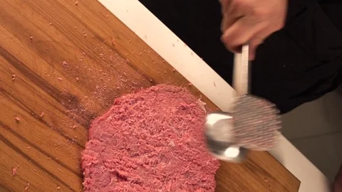 Man in the home kitchen prepares a meat dinner Stock Footage 78153566