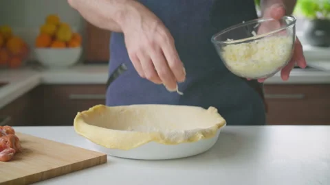 A man at home makes a deep dish pizza with cheese and sausages Stock-Footage 201588785