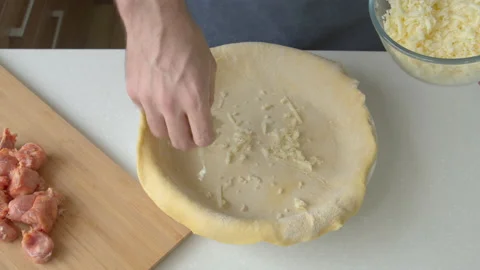 A man at home makes a deep dish pizza with cheese and sausages Stock Footage 219676047