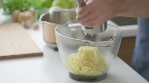 A man at home makes mashed potatoes Stock Footage 201588635