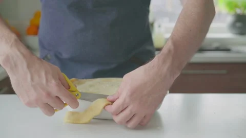 A man at home makes a pie with potatoes and cheese Stock Footage 221470060