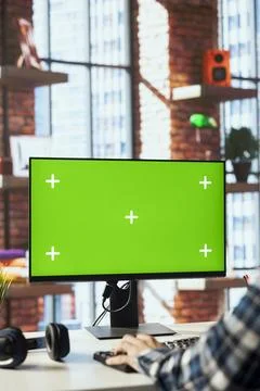 Man at home office desk using green screen computer, composing social media Stock Photos