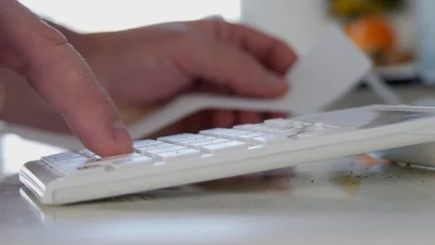 Man at Home Read and Counting Payments from Shopping List Using Adding Machine  Stock Footage 103023545