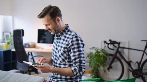Man at home using digital tablet Video stock 126825121