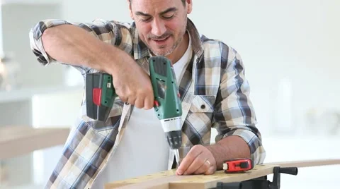 Man at home using electric drill Stock Footage 43051665