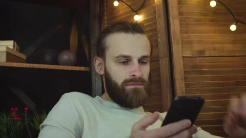 Man at home Using smart phone sending message on social &amp; surprised in the end Stock Footage 147034525