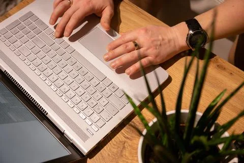 A man at home works at a computer, work from home, home environment with a Stock Photos